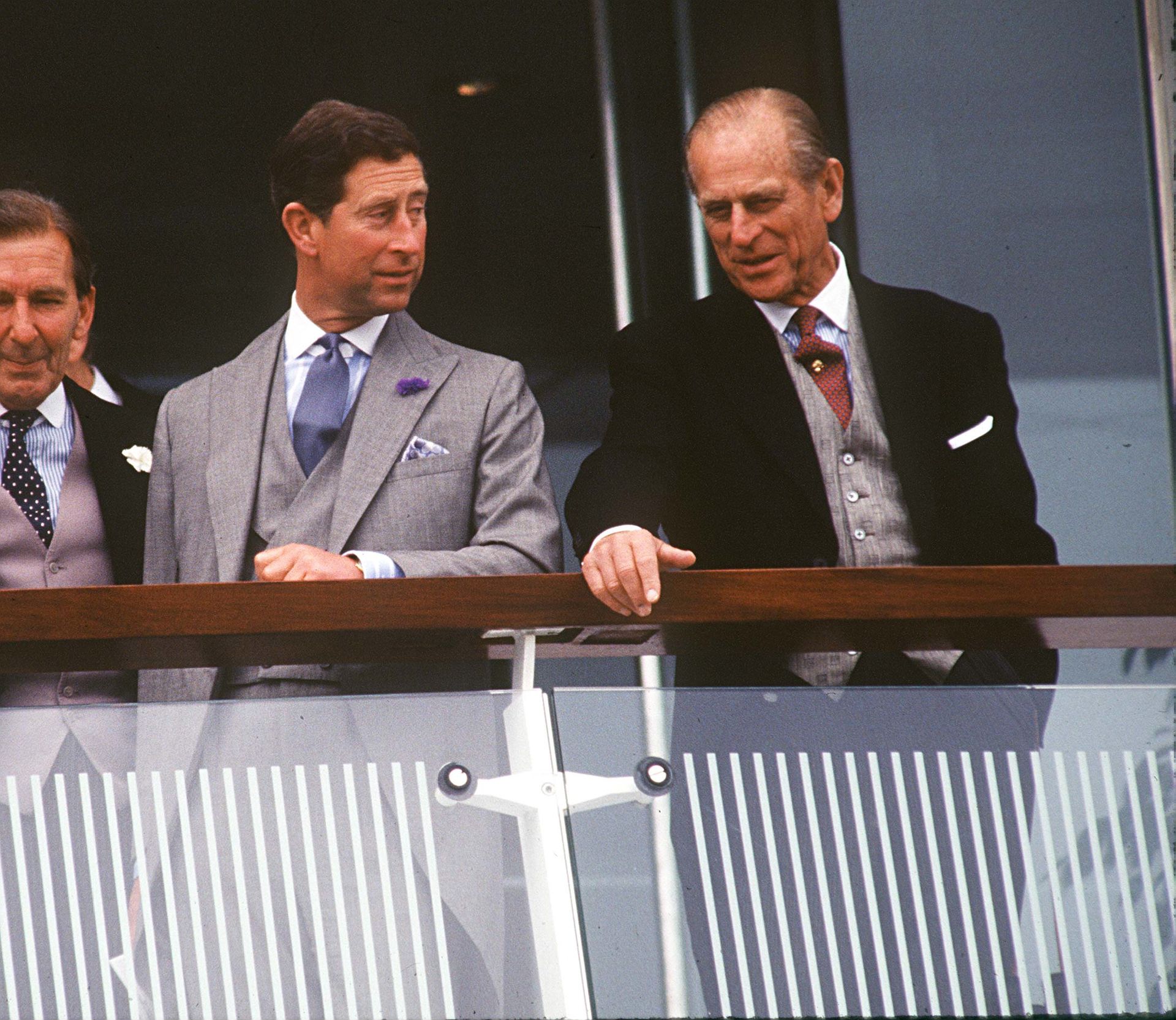 Prince Philip and King Charles wear suits and stand together