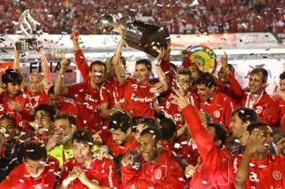 Internacional players celebrate with the Copa Libertadores trophy after victory in the final against Guadalajara in 2010.