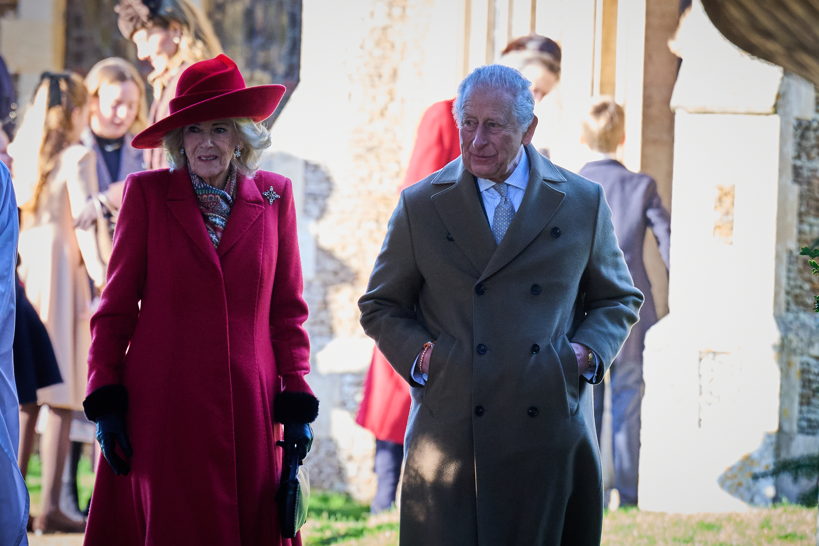 King Charles and Queen Camilla walking from church on Christmas Day in winter coats