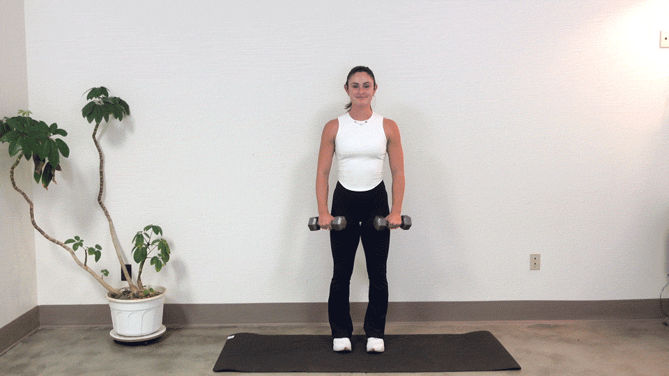 trainer Kirra Mitlo doing dumbbell lateral raises to upright rows