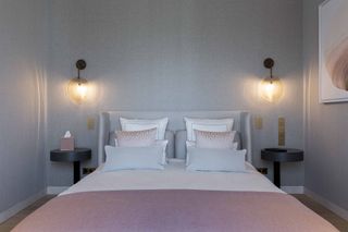 Ina Rinderknecht bedroom in pink and grey with curved headboard and wall lights