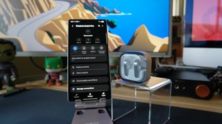 Galaxy Buds4 Pro on a desk, next to a Samsung Galaxy S25 Ultra