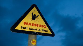 Soft sand and mud warning sign