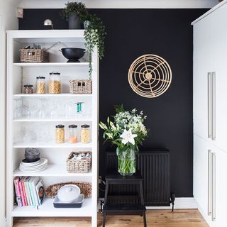 room with black wall and white shelf