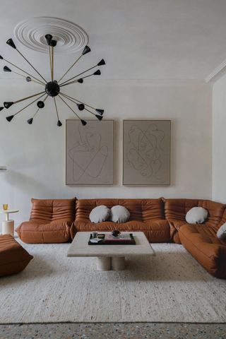 Living room with chandelier and orange sofa