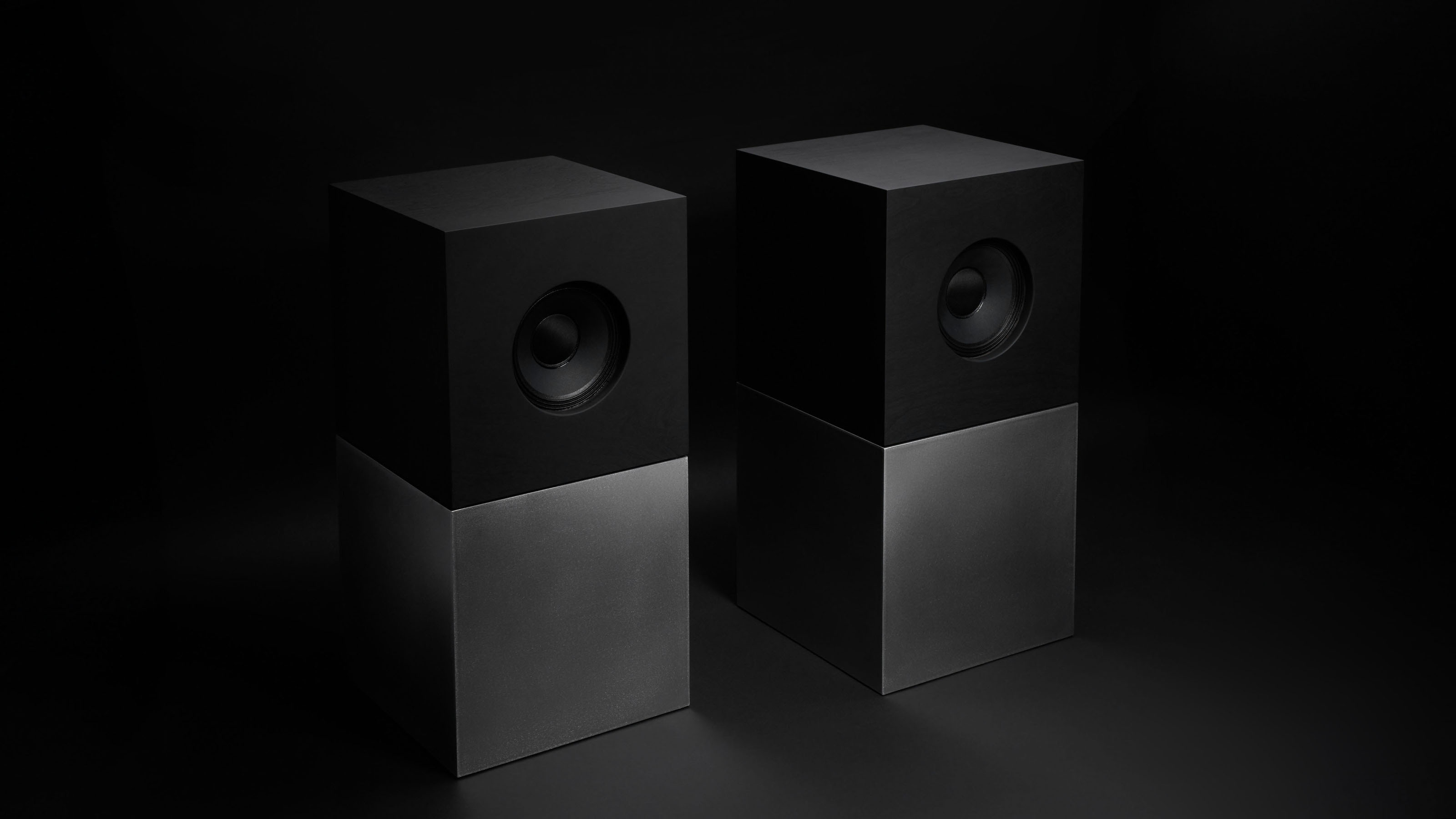 The speaker bases are 25kg brushed steel cubes