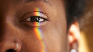 A closeup of an eye with a rainbow.