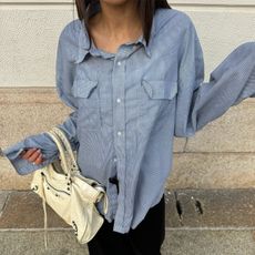 Camelia Farhoodi wearing a Balenciaga bag.