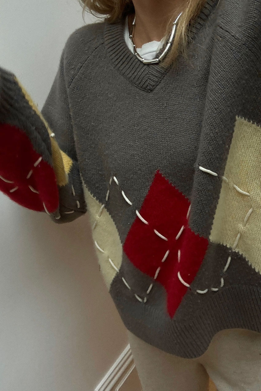 A woman wearing an argyle sweater.