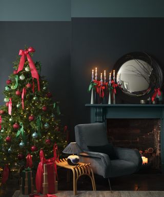 cozy dark living room with Christmas tree with traditional red and green decorations