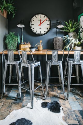 A wooden kitchen breakfast bar with metal bar stools