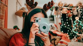 Photographer using instant camera at Christmas