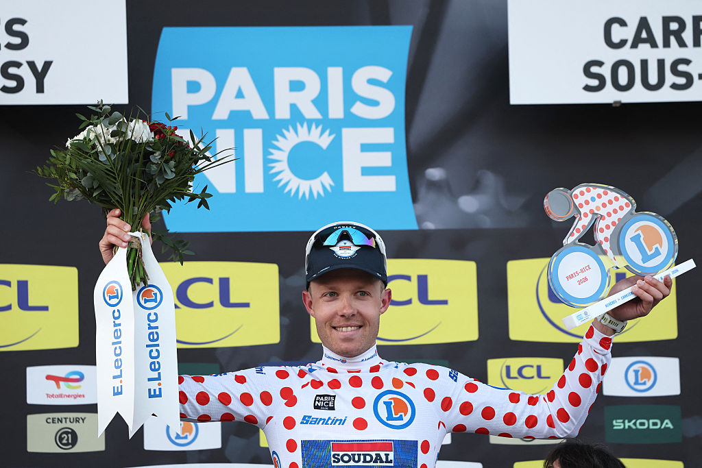 Soudal Quick-Step's Danish rider Casper Pedersen celebrates his white with red polka dots jersey for best climber on the podium after the 1st stage of the Paris-Nice cycling race, 170.9 km between Ach&amp;egrave;res and Carri&amp;egrave;res-sous-Poissy, on March 8, 2026. (Photo by Anne-Christine POUJOULAT / AFP)