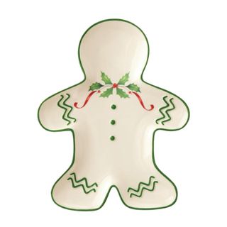 A white gingerbread accent plate with green and red decorations on it