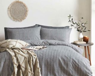flannel striped brushed cotton bed linen in grey in a scandi inspired bedroom with natural accessories - the linen yard