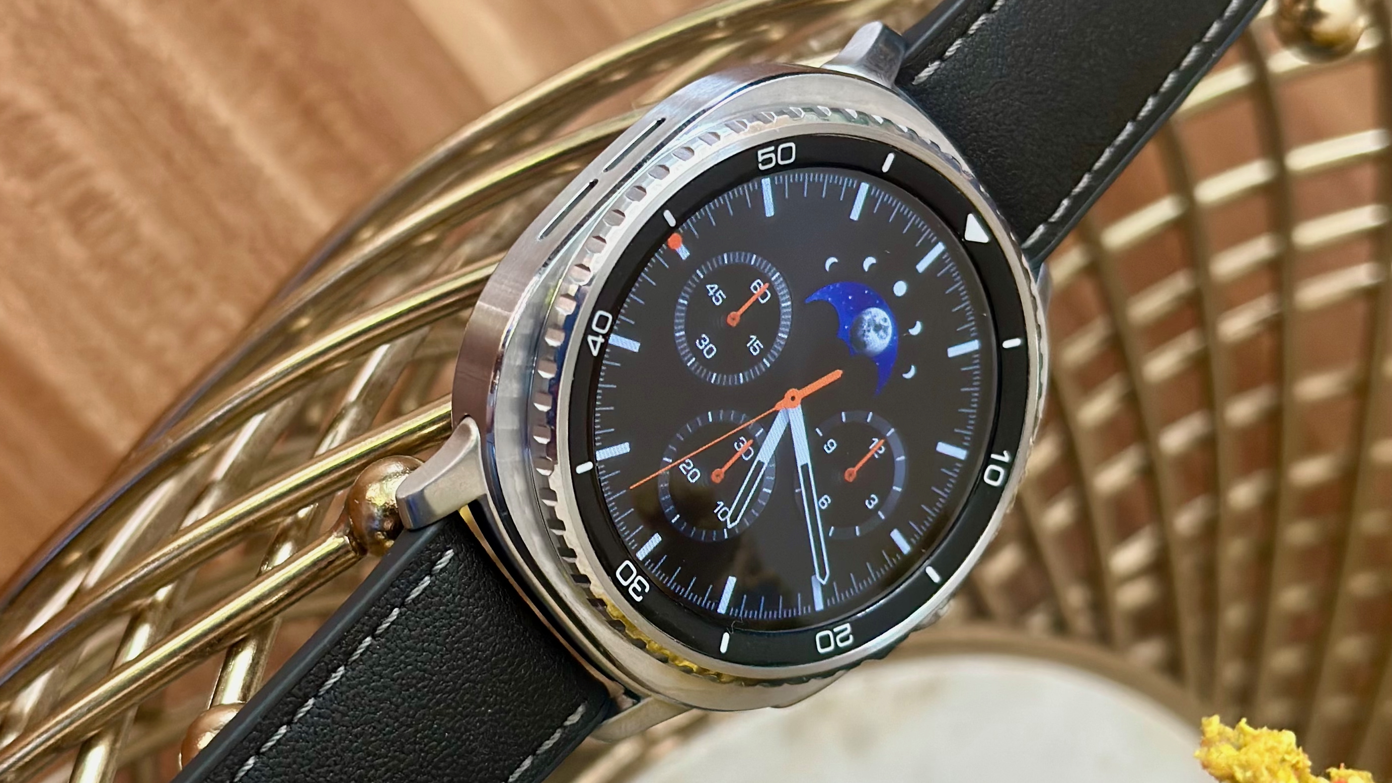 A close-up of the Samsung Galaxy Watch 8 Classic showing the default watch face, display border, and rotating bezel.