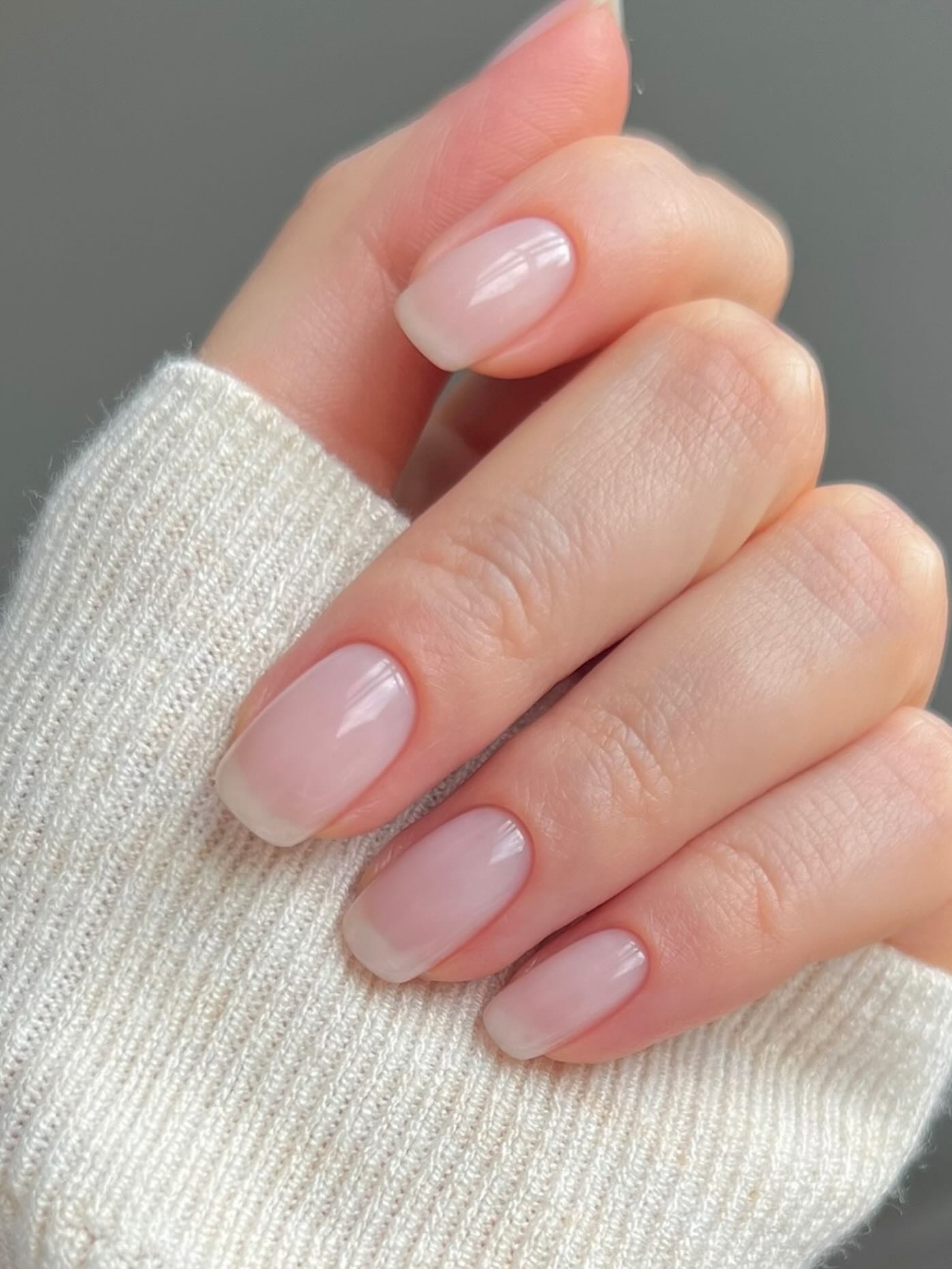 A really sheer, natural-looking manicure on long, square nails