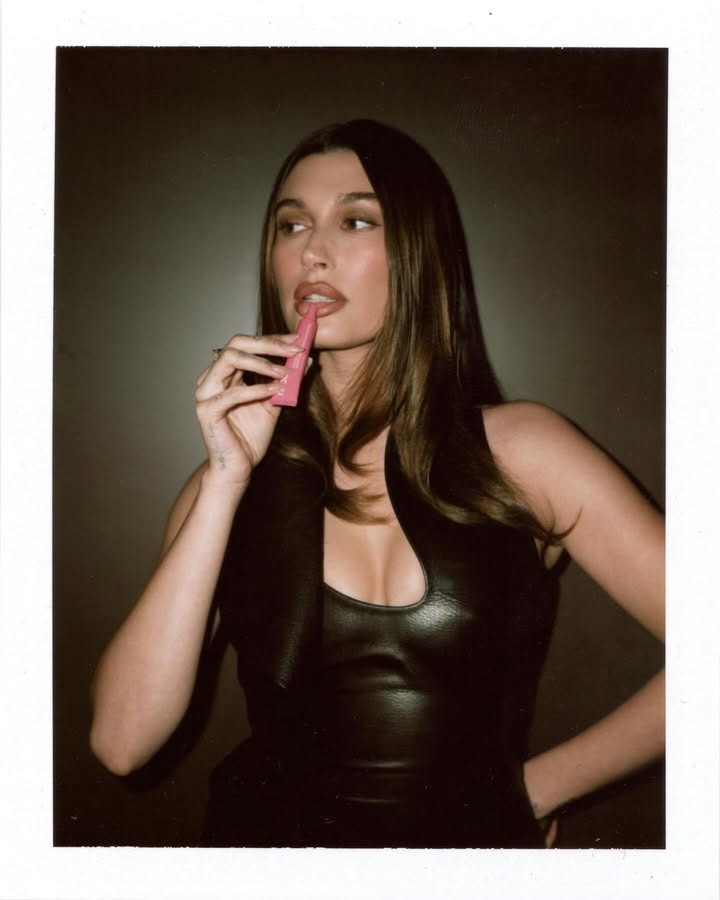 Hailey Bieber applying the Rhode Peptide Lip Treatment.
