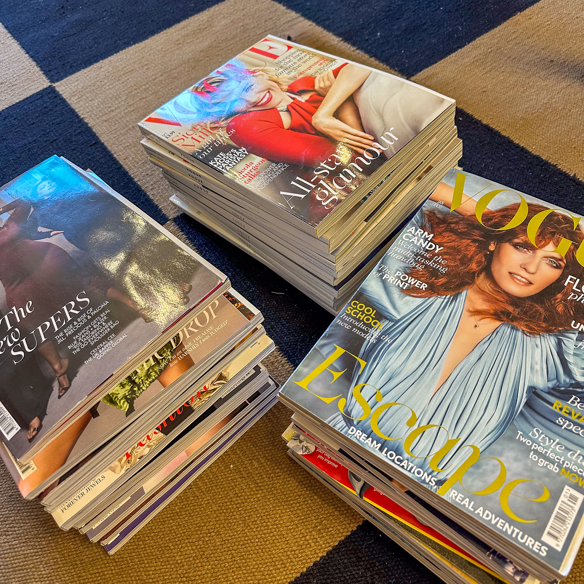 Three stacks of vintage Vogue magazines