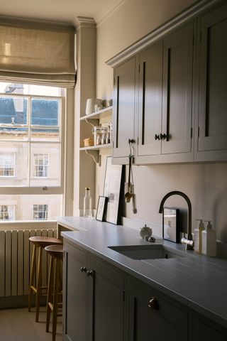 Grey galley kitchen in a small apartment with traditional cabinets