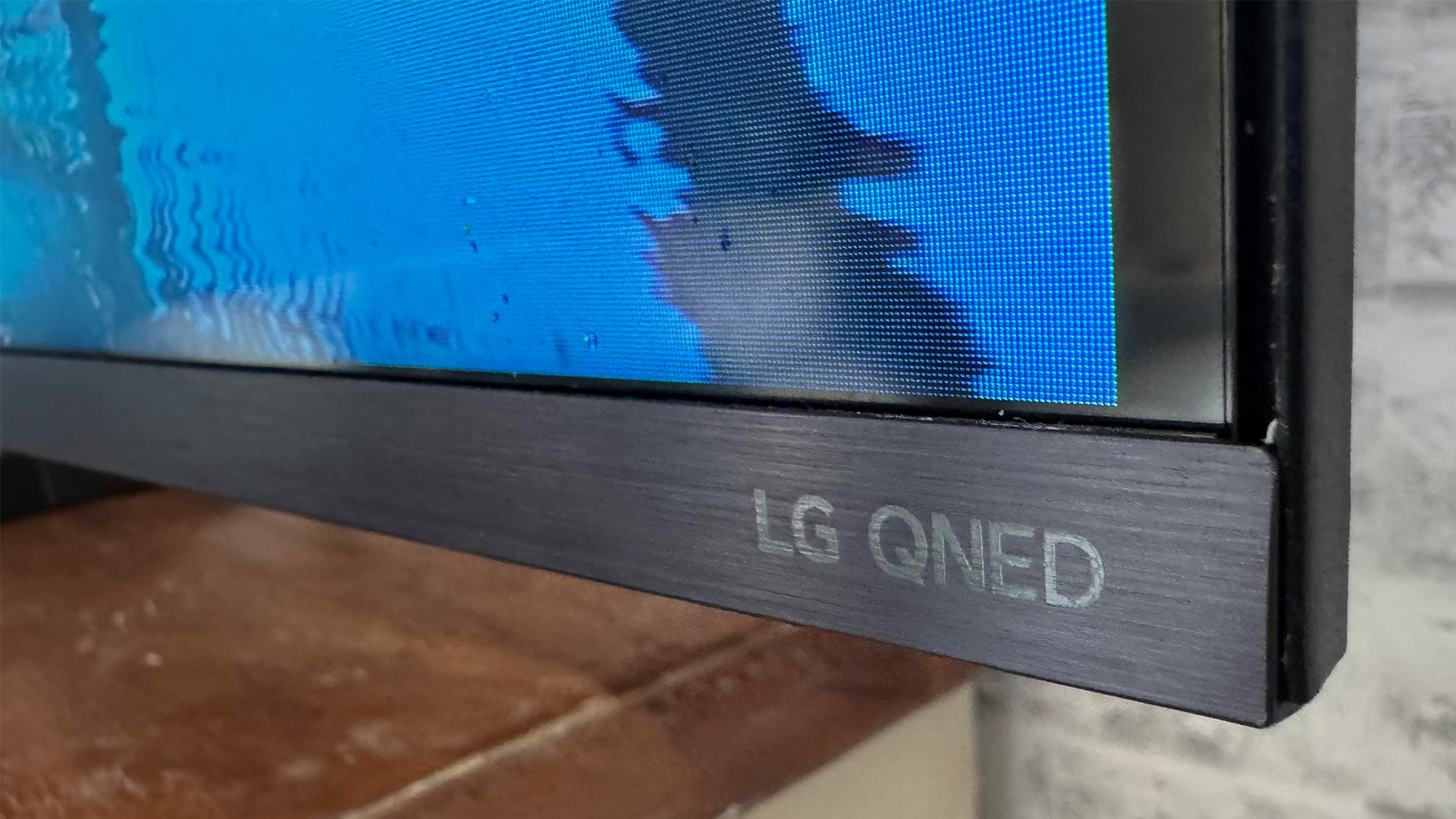 LG 65QNED93 LCD TV close up on bottom right corner of screen and LG QNED logo