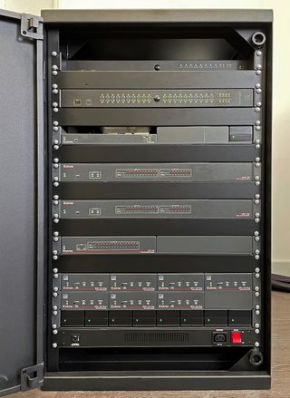 A closeup of Extron hardware stacked in a cabinet.