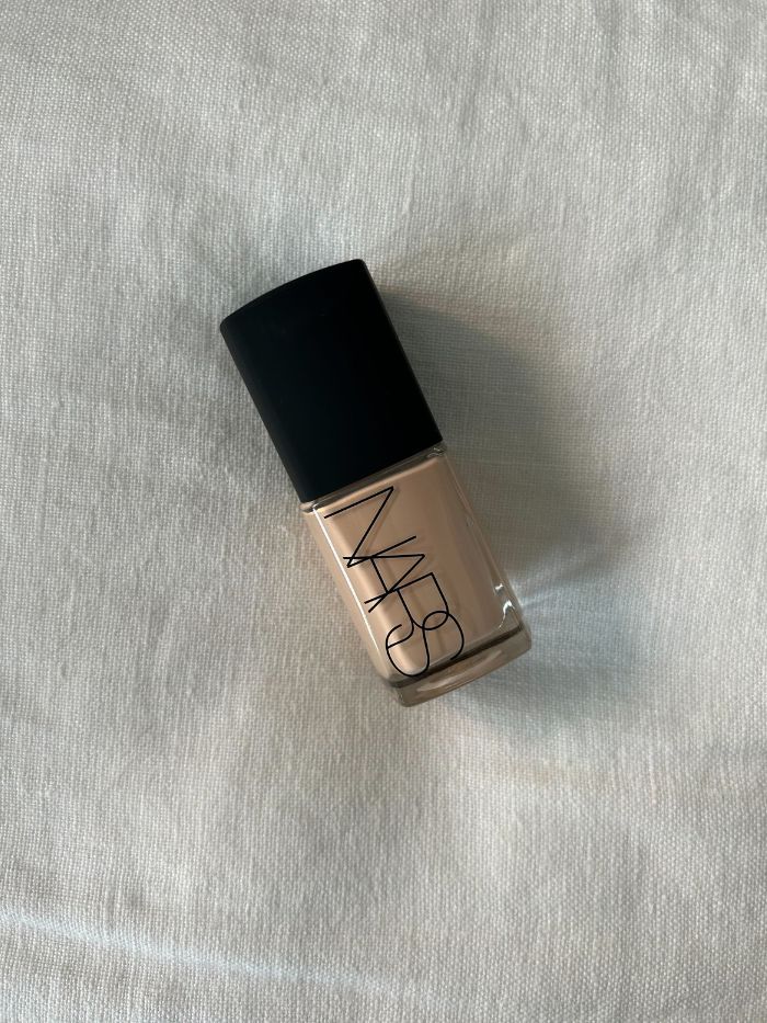 Nars Sheer Glow Foundation on a white linen background