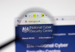 An image showing the NCSC logo on its website under a magnifying glass