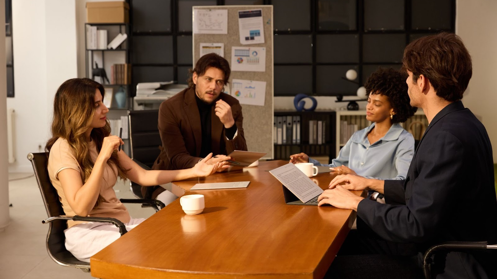 A group of workers sit around a table during a meeting