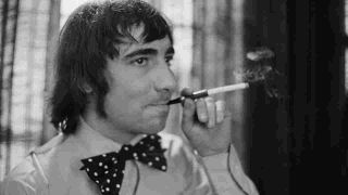 The Who’s Keith Moon wearing a bow tie and smoking a cigarette in the early 70s