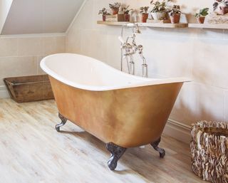 gold rolltop bath in bathroom