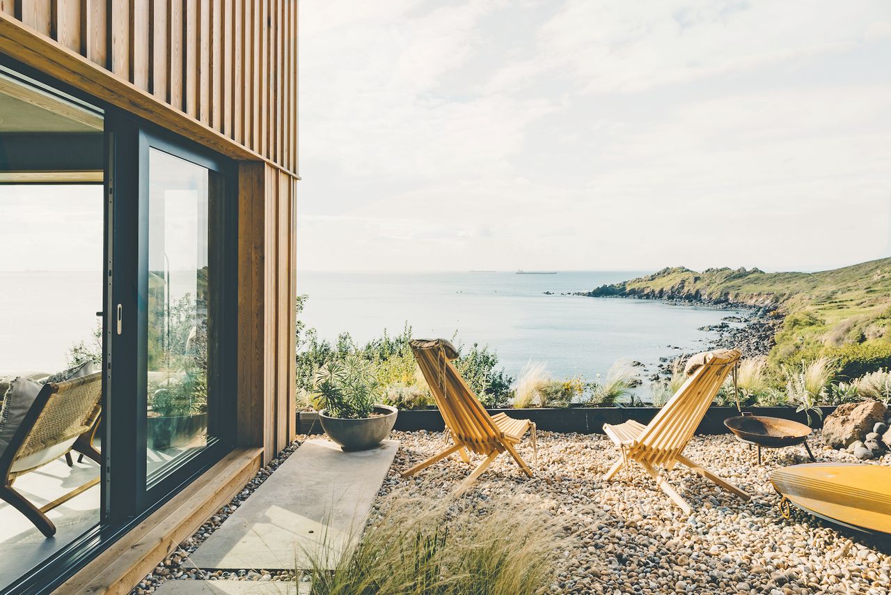outdoor gravel garden with two sun loungers