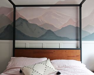A bedroom wall painted ombre-style in a mountain mural