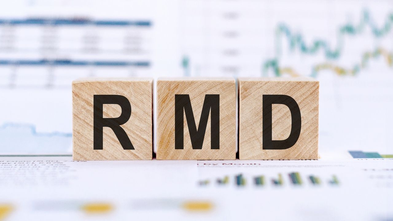 Blocks spell out RMD against the backdrop of financial paperwork.