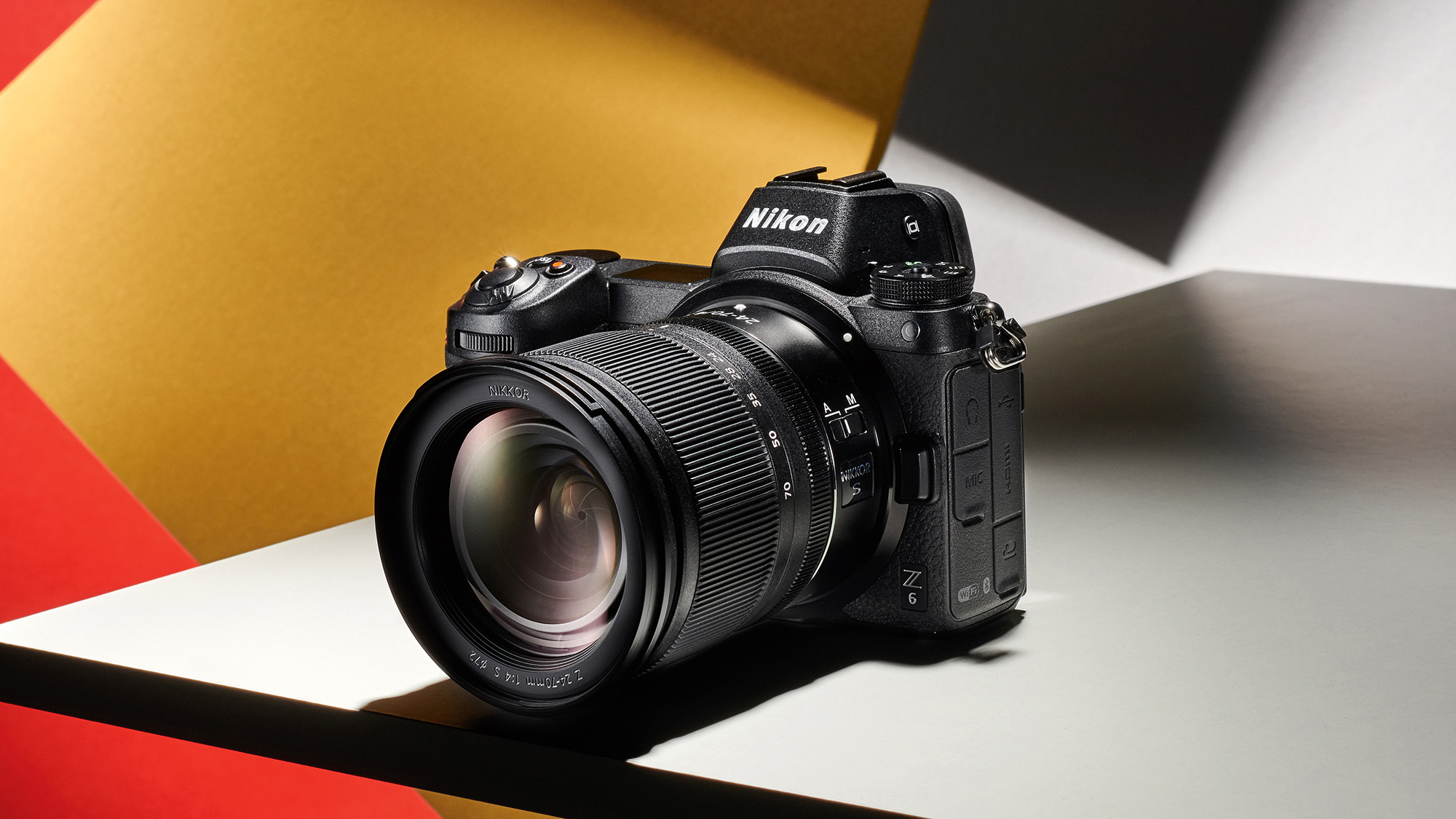 Nikon Z6 product image on a yellow, red, and grey background 