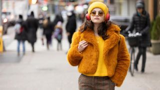 A press photo of Selena Gomez in yellow fuzzy coat from Season 1 of Only Murders in the Building.