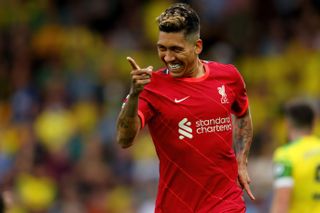 Roberto Firmino celebrates after scoring for Liverpool against Norwich City, 2021