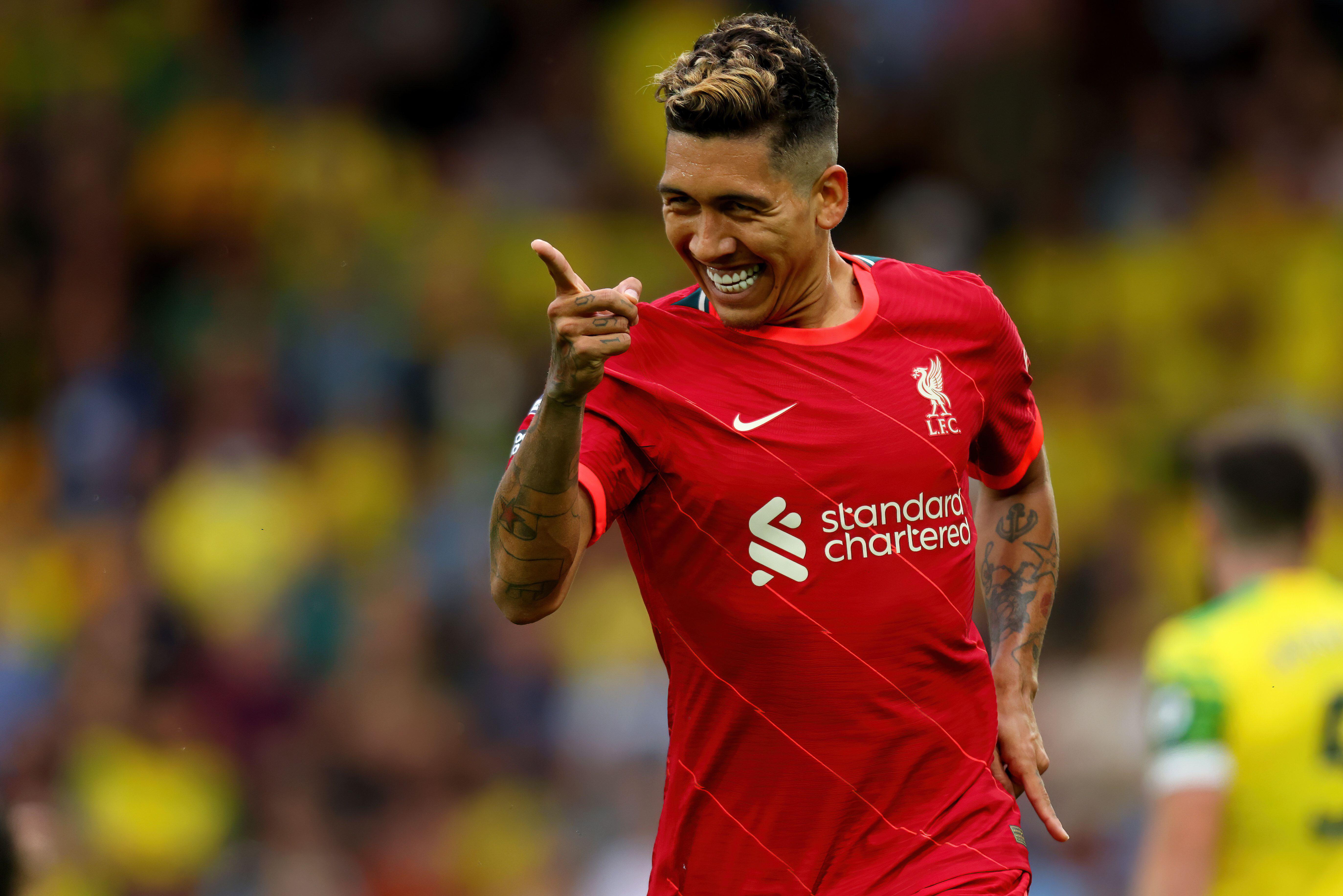 Roberto Firmino celebrates after scoring for Liverpool against Norwich City, 2021