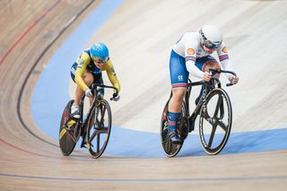 Alla Biletska cycles behind Sophie Capewell on the boards of the Grenchen Velodrome