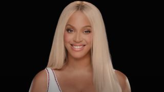 A screenshot of Beyoncé smiling and no wearing a cowboy hat in her 2024 Paris Olympics Team USA ad.