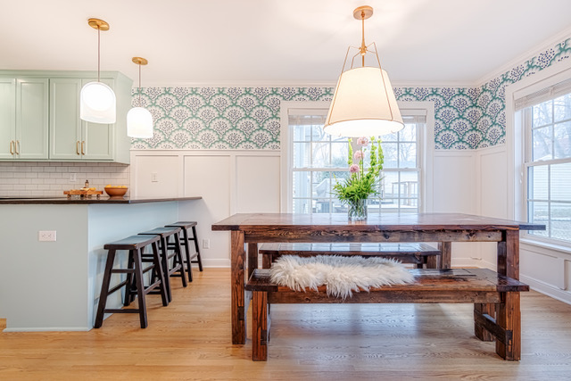 White wall paneling with blue print wallpaper above to complement blue cabinetry