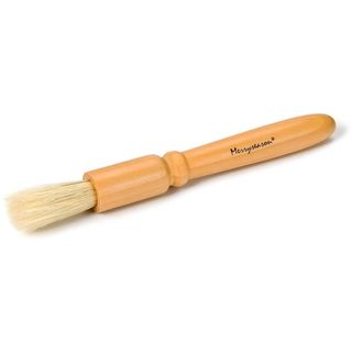 A wooden coffee machine cleaning brush with white bristles