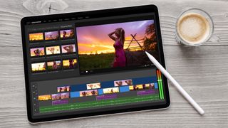 iPad with video editing software on it with an Apple Pencil and coffee next to it