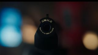 A close up shot of the 'Smile' phrase on Deadpool's handguns in Deadpool and Wolverine