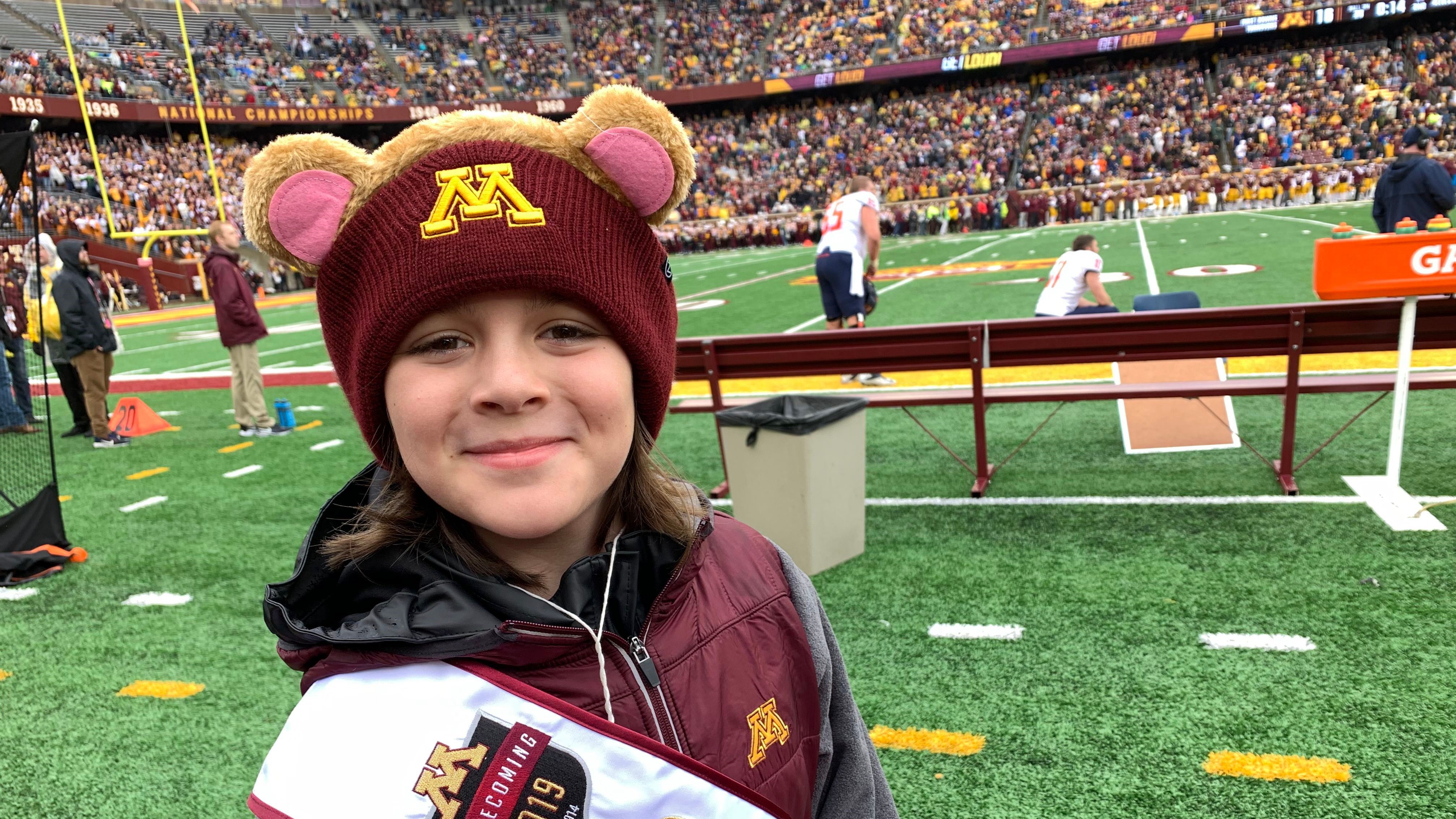 Elliot joins fellow students at a football game.