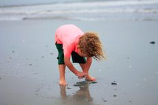 This boy won&rsquo;t remember all the shells he digs up, but he&rsquo;ll learn that the beach is the place to find them.