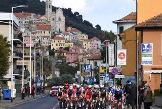 SANREMO ITALY MARCH 20 Adrien Petit of France and Team Total Direct Energie Luke Durbridge of Australia and Team BikeExchange Tim Declercq of Belgium and Team Deceuninck QuickStep The Peloton passing through ImperiaOneglia Village during the 112th MilanoSanremo 2021 a 299km race from Milano to Sanremo Fans Public Landscape MilanoSanremo La Classicissima UCIWT on March 20 2021 in Sanremo Italy Photo by Tim de WaeleGetty Images