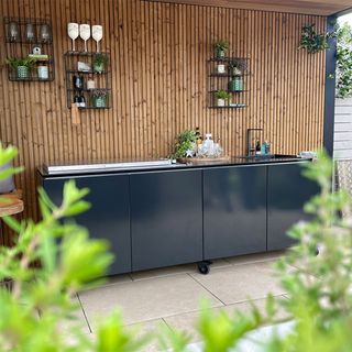 garden area with outdoor kitchen and black kitchen counter