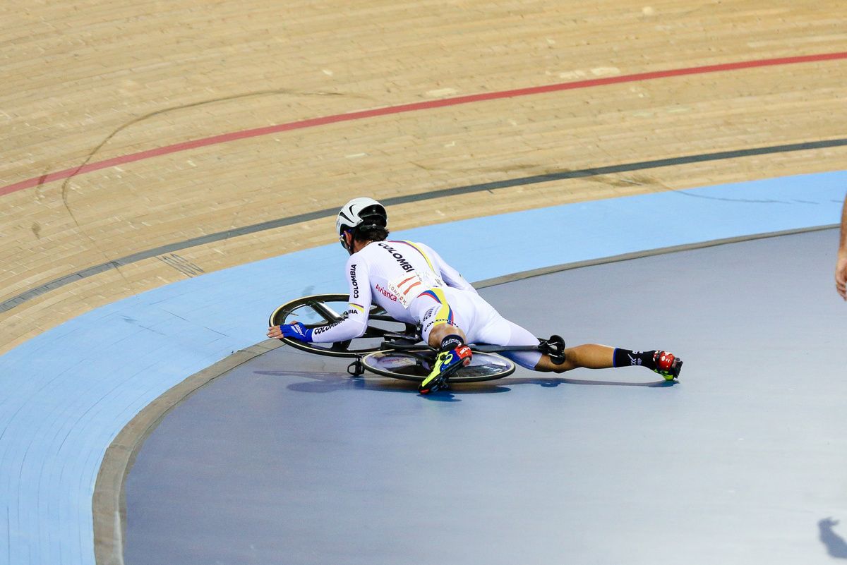 Fernando Gaviria sliding along the ground after crashing in the madison
