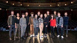 The cast of Shadow and Bone photographed together on a theatre stage